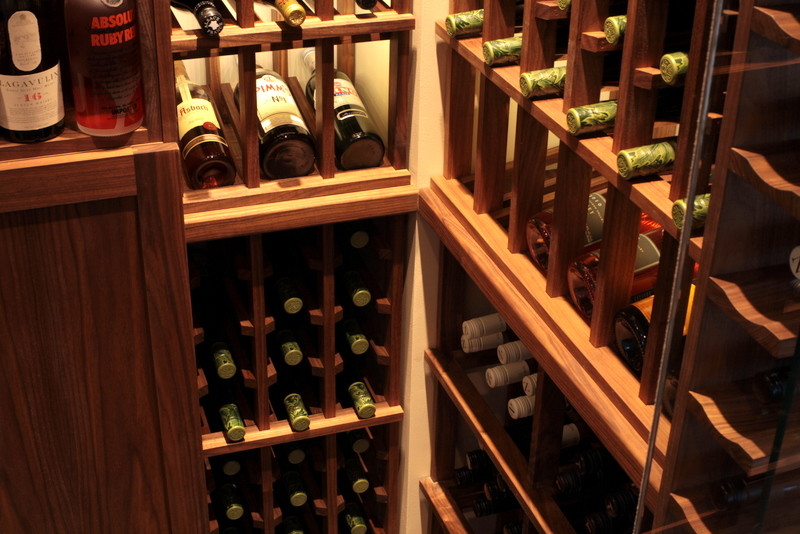 This is an example of a mid-sized transitional wine cellar in Vancouver with porcelain floors and storage racks.