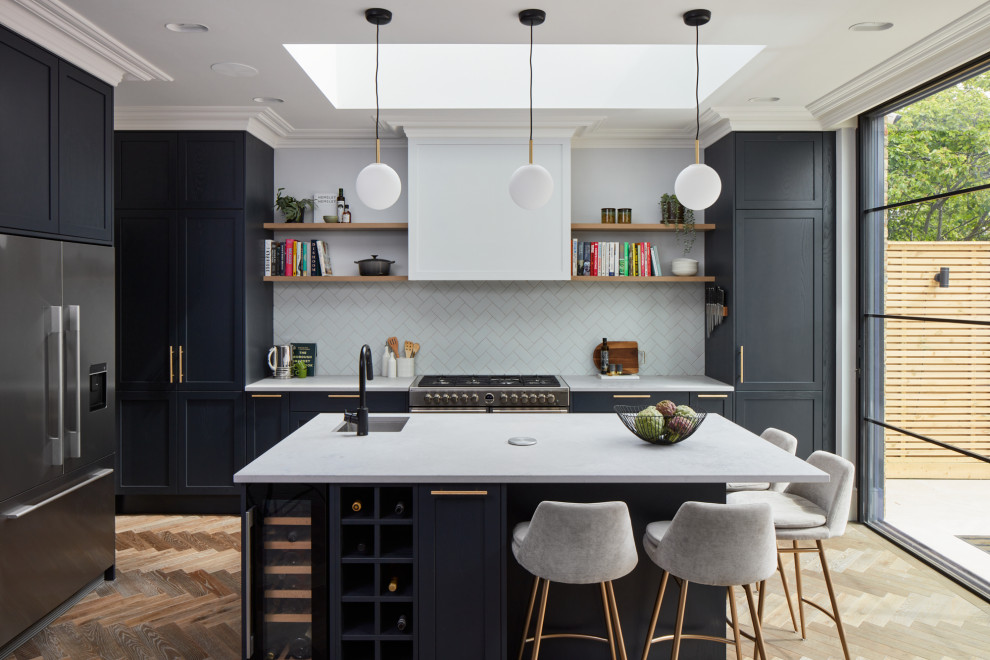 Design ideas for a large transitional l-shaped open plan kitchen in London with shaker cabinets and with island.