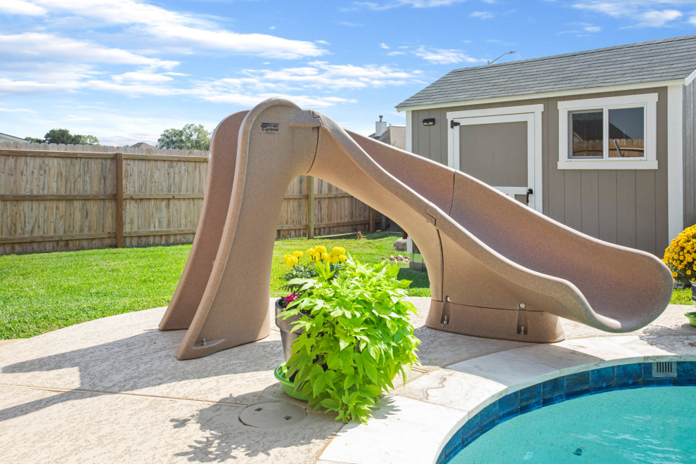 Mid-sized backyard custom-shaped natural water slide photo in Austin with decking