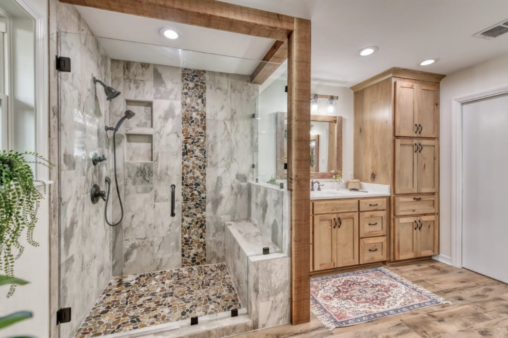 Inspiration for a mid-sized country master bathroom in Other with an alcove shower, a two-piece toilet, gray tile, stone tile, white walls, wood-look tile, an undermount sink, engineered quartz benchtops, brown floor, a hinged shower door, white benchtops, an enclosed toilet, a double vanity and a built-in vanity.