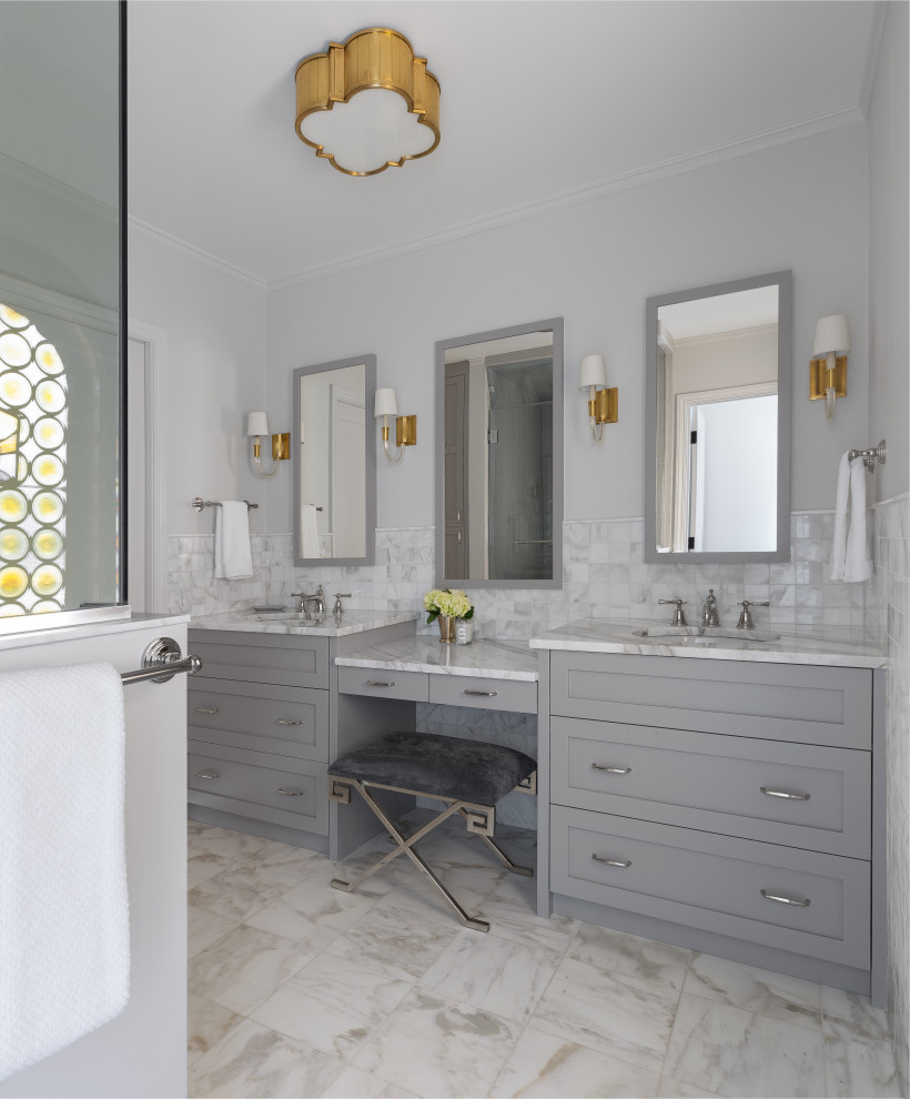 Inspiration for a mid-sized transitional master bathroom in Seattle with shaker cabinets, grey cabinets, an alcove shower, a two-piece toilet, white tile, marble, grey walls, marble floors, an undermount sink, marble benchtops, white floor, a hinged shower door and white benchtops.