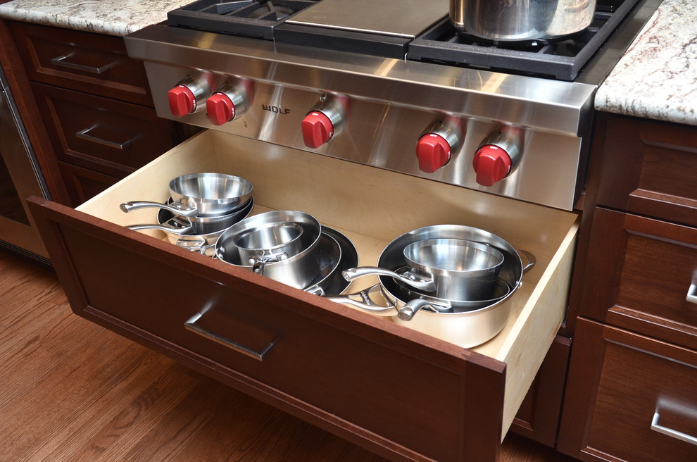 Mid-sized transitional medium tone wood floor eat-in kitchen photo in Portland with an undermount sink, recessed-panel cabinets, medium tone wood cabinets, granite countertops, beige backsplash, porcelain backsplash, stainless steel appliances and an island