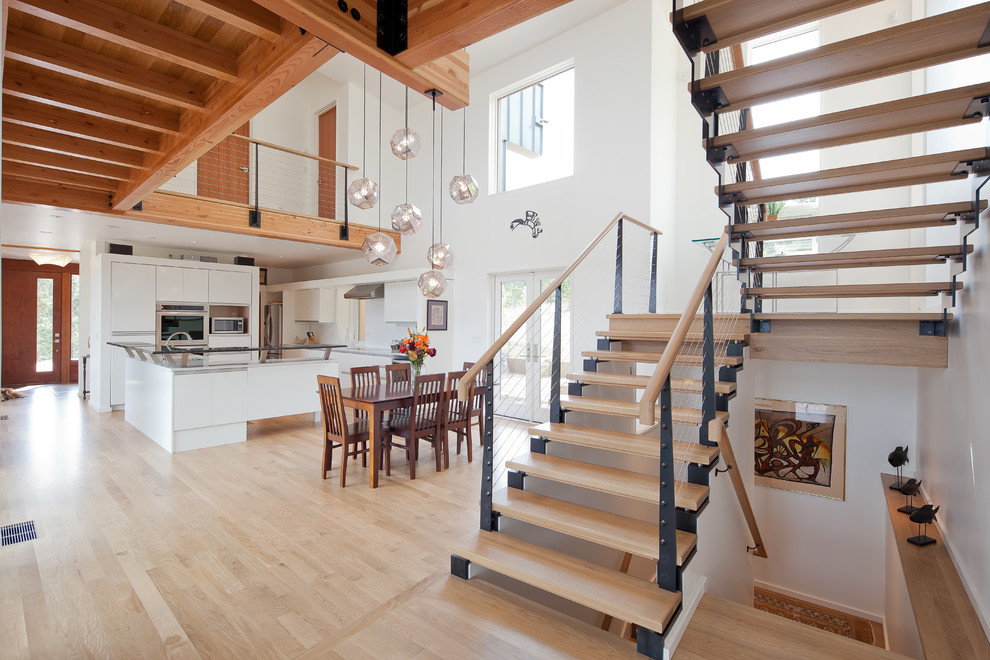 Inspiration for a contemporary kitchen/dining combo in Portland with white walls and light hardwood floors.