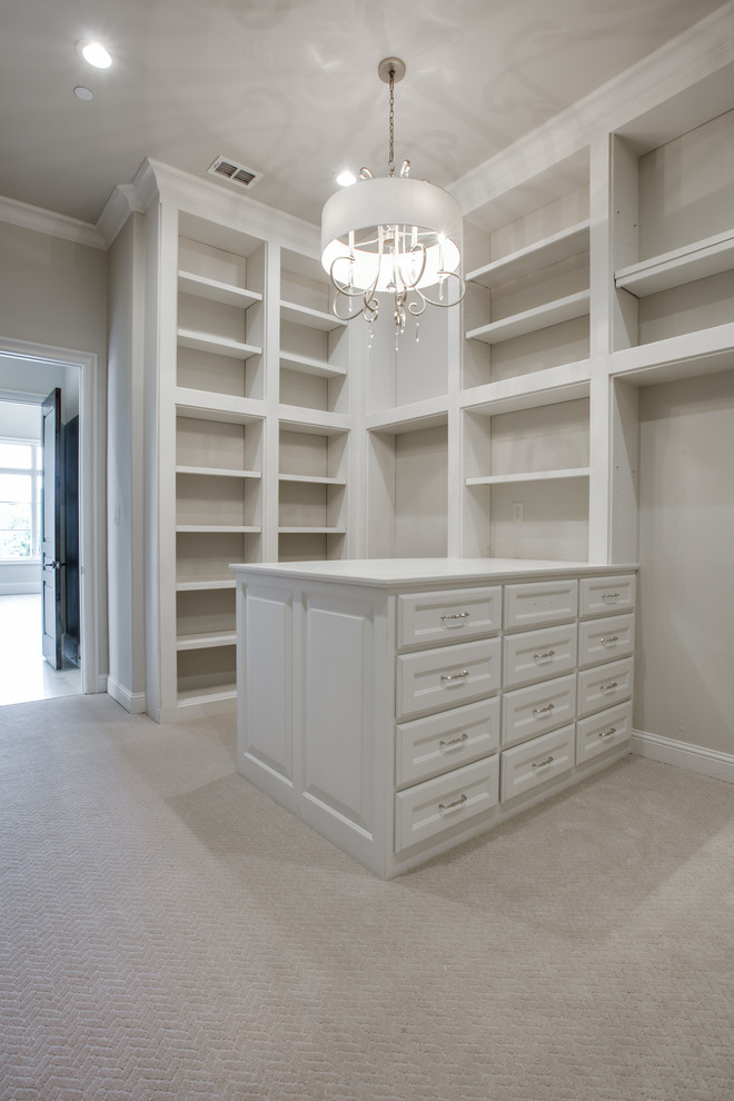Design ideas for a transitional gender-neutral dressing room in Dallas with white cabinets and carpet.