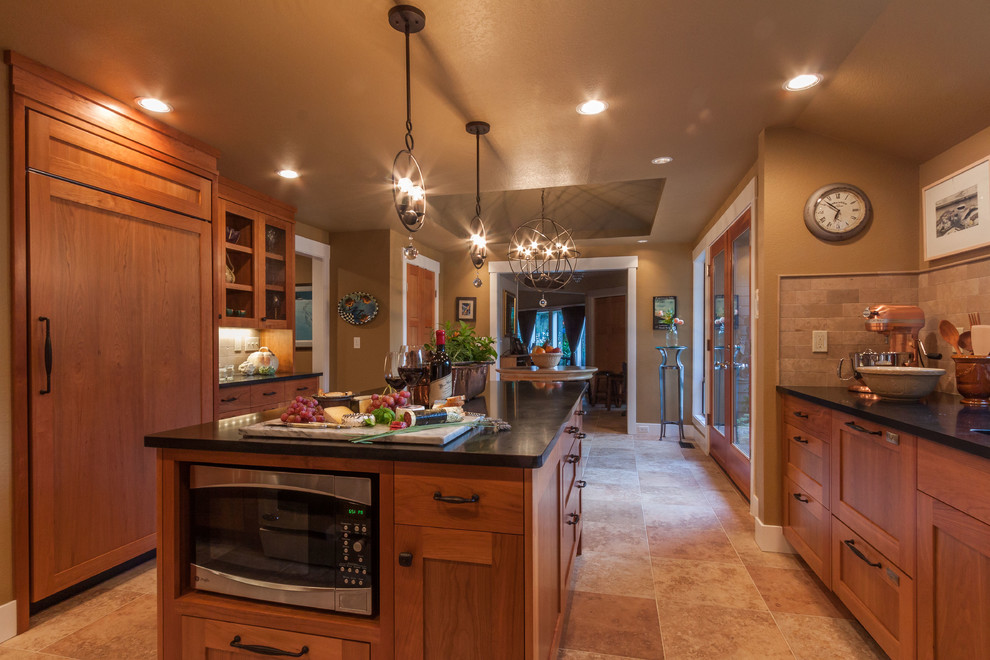 Open concept kitchen - large transitional porcelain tile and beige floor open concept kitchen idea in Seattle with an undermount sink, shaker cabinets, medium tone wood cabinets, solid surface countertops, beige backsplash, stone tile backsplash, stainless steel appliances and an island