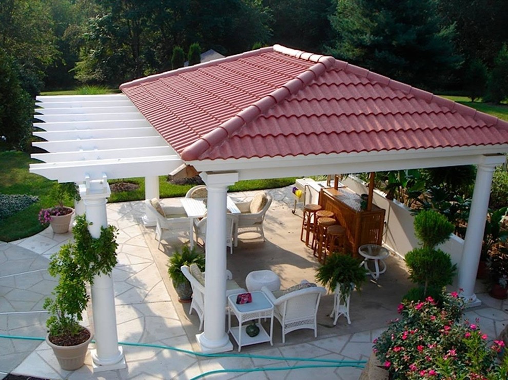 Patio - large transitional backyard stone patio idea in DC Metro with a roof extension