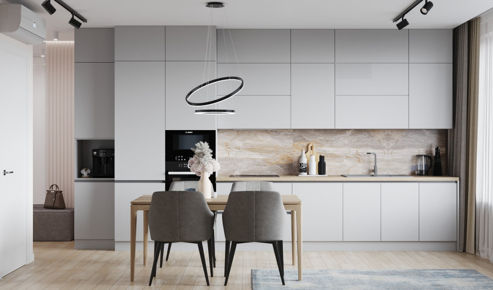 Imagen de cocina comedor lineal nórdica de tamaño medio con puertas de armario grises y electrodomésticos negros