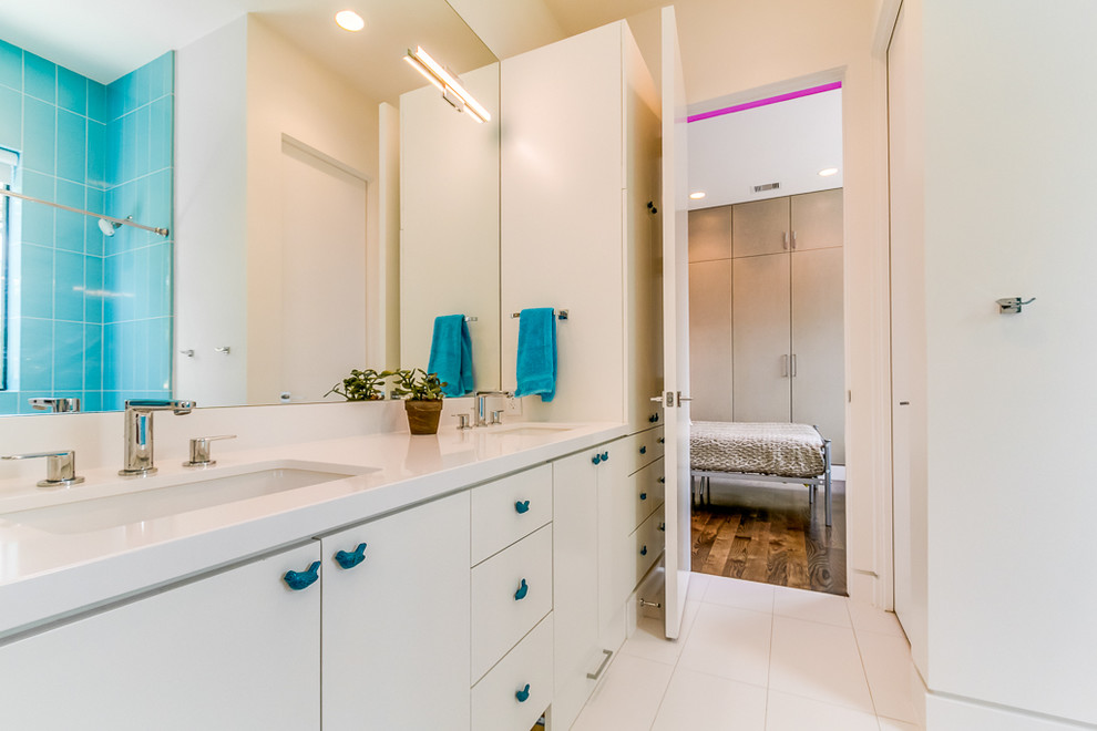 Inspiration for a small modern kids bathroom in Houston with flat-panel cabinets, white cabinets, white tile, ceramic tile, white walls, ceramic floors, an undermount sink, engineered quartz benchtops and white floor.