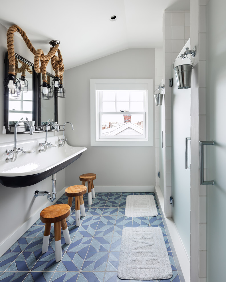 Inspiration for a beach style kids bathroom in Other with an alcove shower, grey walls, cement tiles, a trough sink, blue floor and a hinged shower door.
