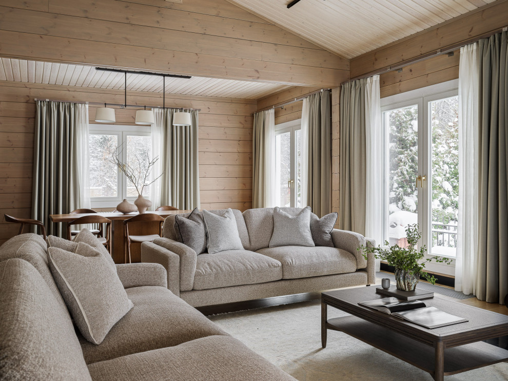 На фото: гостиная комната в стиле рустика с паркетным полом среднего тона, зоной отдыха и деревянными стенами с