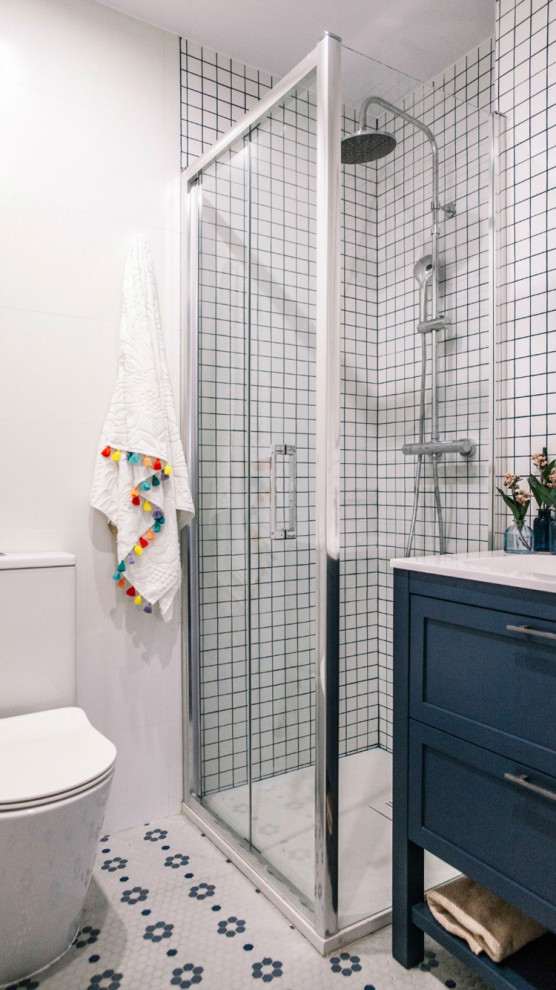 Small transitional kids bathroom in Other with furniture-like cabinets, blue cabinets, a curbless shower, mosaic tile, white walls, mosaic tile floors, white floor, a sliding shower screen and white benchtops.