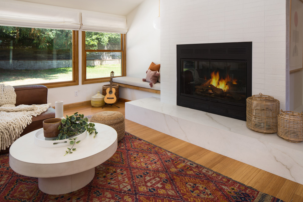 Inspiration for a mid-sized scandinavian formal open concept living room in Los Angeles with white walls, bamboo floors, a standard fireplace, a tile fireplace surround, no tv and yellow floor.