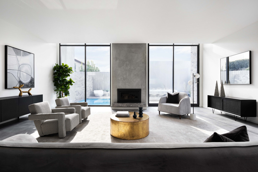 Photo of a contemporary open concept living room in Melbourne with white walls, porcelain floors, a standard fireplace, a concrete fireplace surround and grey floor.