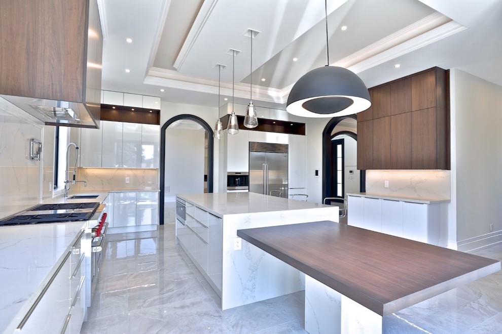 Design ideas for a large modern kitchen in Toronto with an undermount sink, flat-panel cabinets, white cabinets, quartz benchtops, yellow splashback, marble splashback, stainless steel appliances, porcelain floors, with island, beige floor and yellow benchtop.