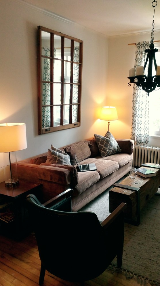 Example of a small urban open concept and formal light wood floor living room design in Montreal with a wall-mounted tv, white walls and no fireplace
