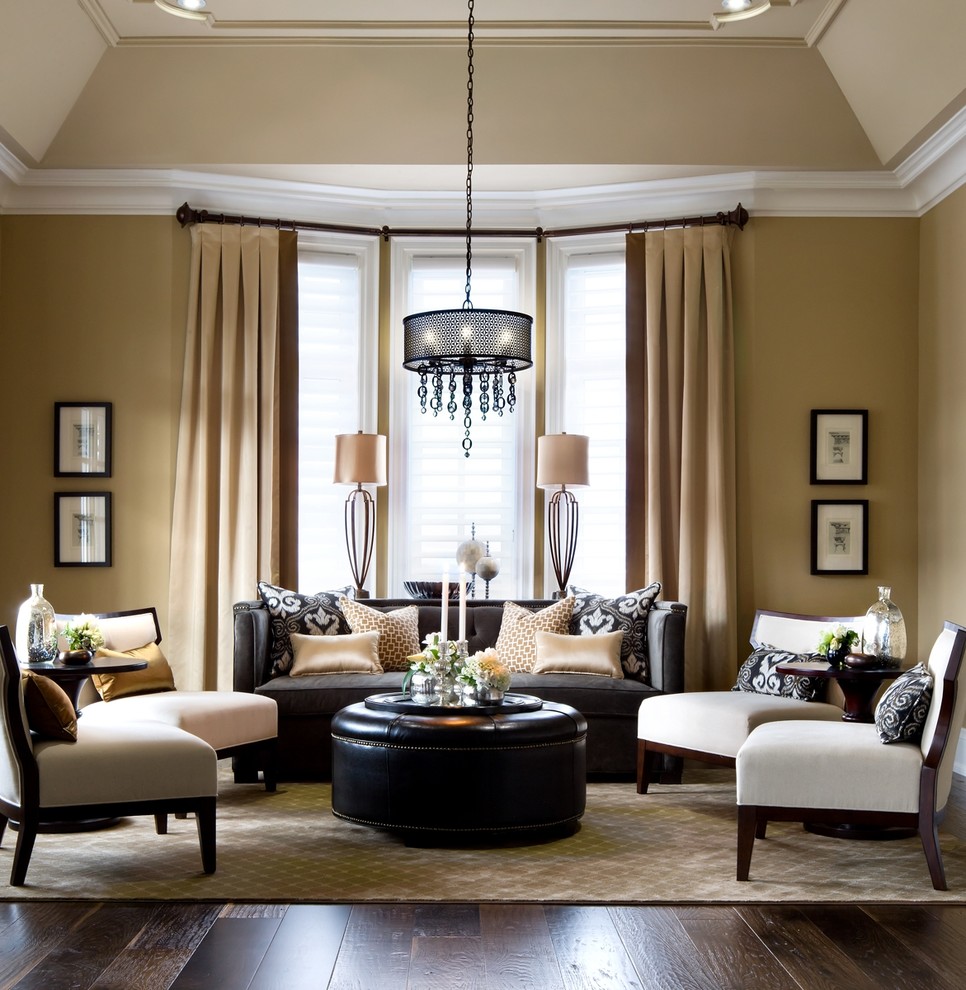 Traditional formal living room in Toronto with brown walls, dark hardwood floors and no tv.