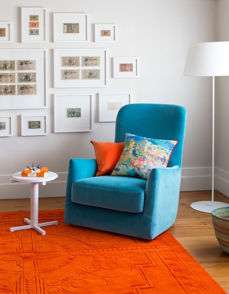 Mid-sized contemporary home office in Melbourne with white walls and medium hardwood floors.