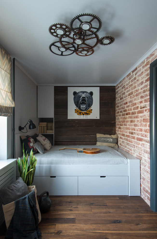 This is an example of an industrial kids' room for boys in Moscow with medium hardwood floors and brown floor.