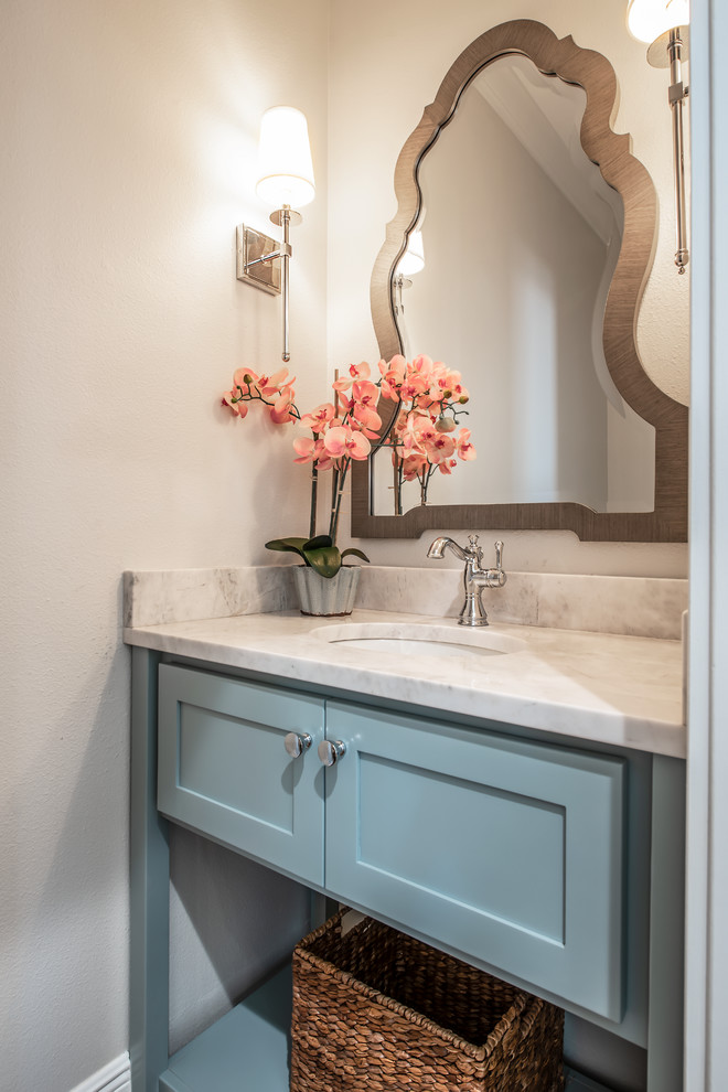 This is an example of a mid-sized country powder room in Tampa with shaker cabinets, blue cabinets, grey walls, an undermount sink, granite benchtops and grey benchtops.