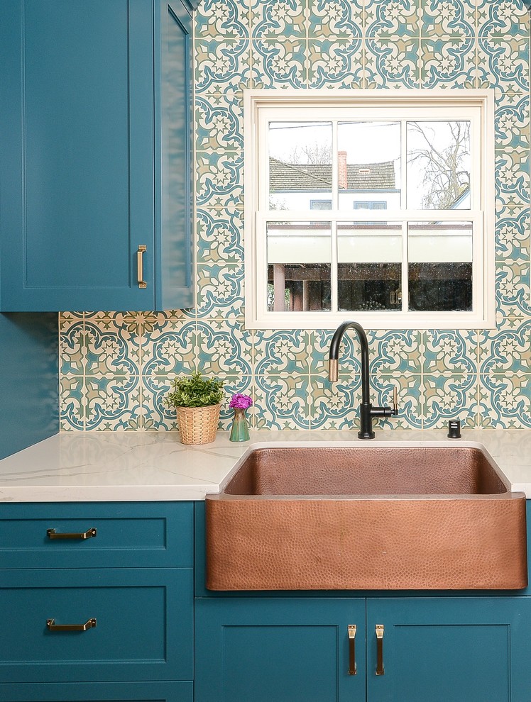 Design ideas for a mediterranean kitchen in Sacramento with shaker cabinets, turquoise cabinets, solid surface benchtops, terra-cotta floors, with island and white benchtop.