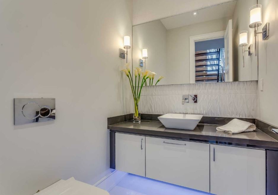Mid-sized minimalist white tile and porcelain tile porcelain tile powder room photo in Toronto with flat-panel cabinets, white cabinets, a wall-mount toilet, white walls, a vessel sink and quartz countertops
