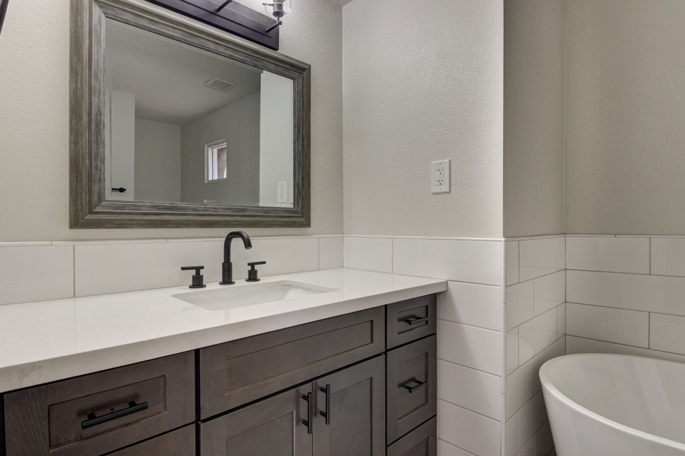 Mid-sized transitional master white tile and subway tile double-sink freestanding bathtub photo in Phoenix with shaker cabinets, brown cabinets, an undermount sink, quartz countertops, white countertops and a built-in vanity