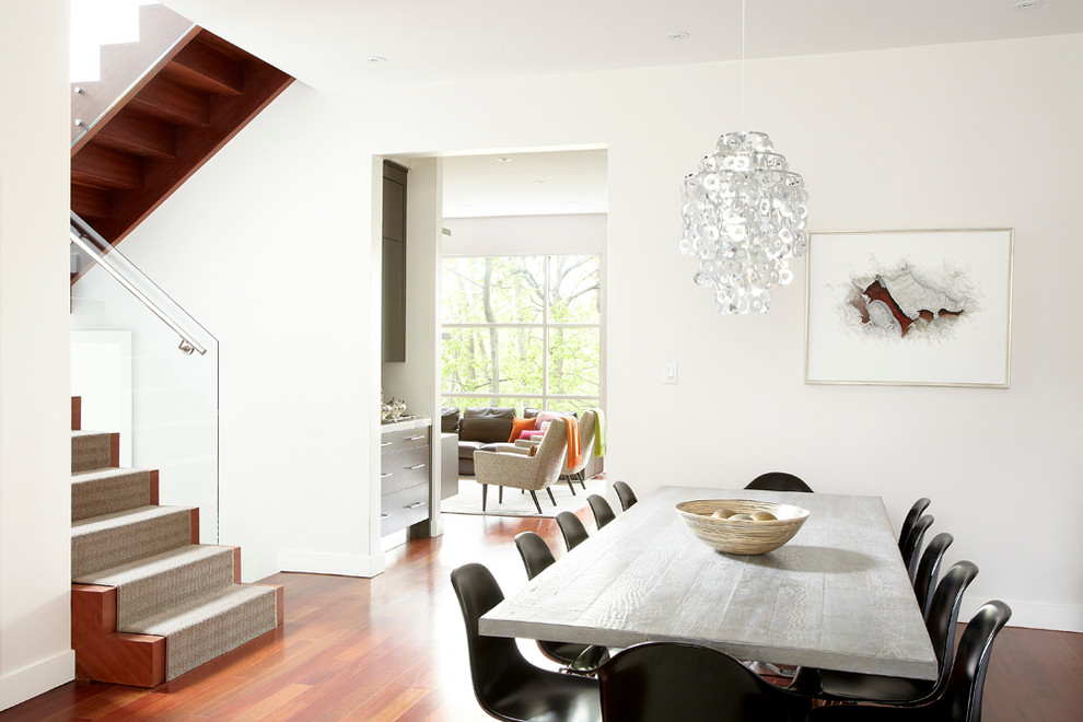 This is an example of a contemporary dining room in Toronto with white walls.