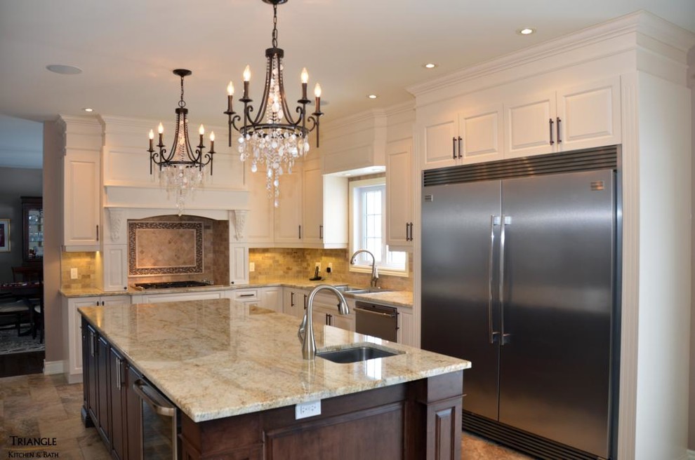 Photo of a mid-sized transitional l-shaped kitchen in Ottawa with a triple-bowl sink, raised-panel cabinets, white cabinets, marble benchtops, beige splashback, stone tile splashback, stainless steel appliances and with island.