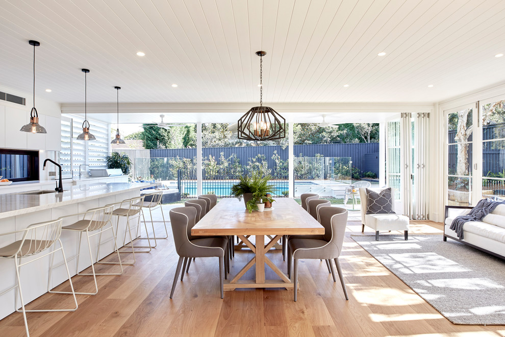 Design ideas for a contemporary open plan dining in Sydney with white walls, medium hardwood floors and brown floor.