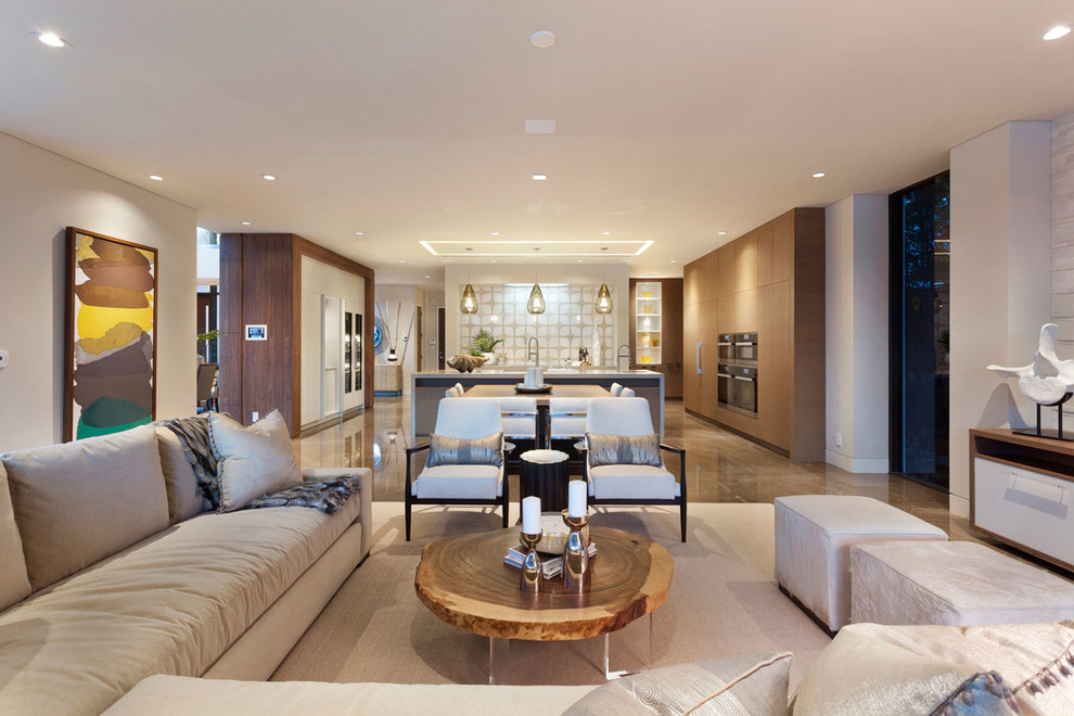 This is an example of a large modern open concept family room in Miami with beige walls and marble floors.