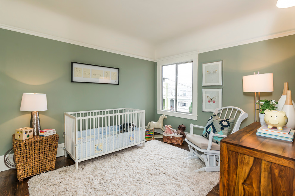 This is an example of a mid-sized transitional gender-neutral nursery in San Francisco with green walls, dark hardwood floors and brown floor.