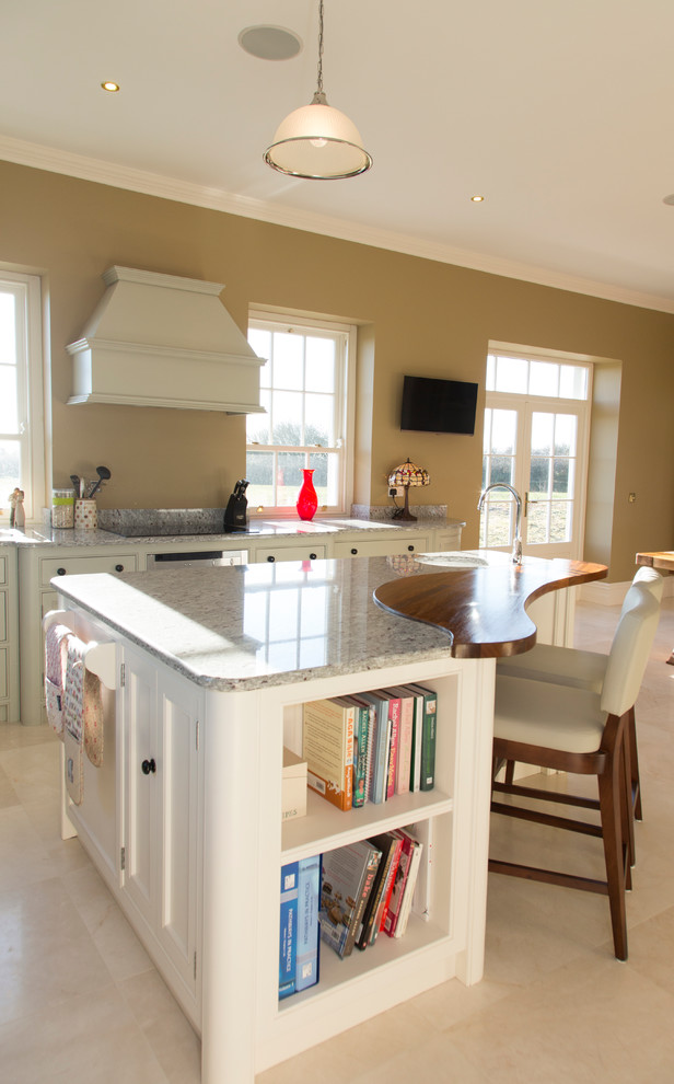 This is an example of a large traditional l-shaped eat-in kitchen in Cork with an undermount sink, granite benchtops, stainless steel appliances, porcelain floors and with island.