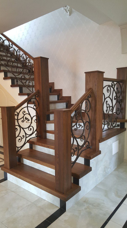 Inspiration for a large traditional wood staircase in Moscow with concrete risers and mixed railing.