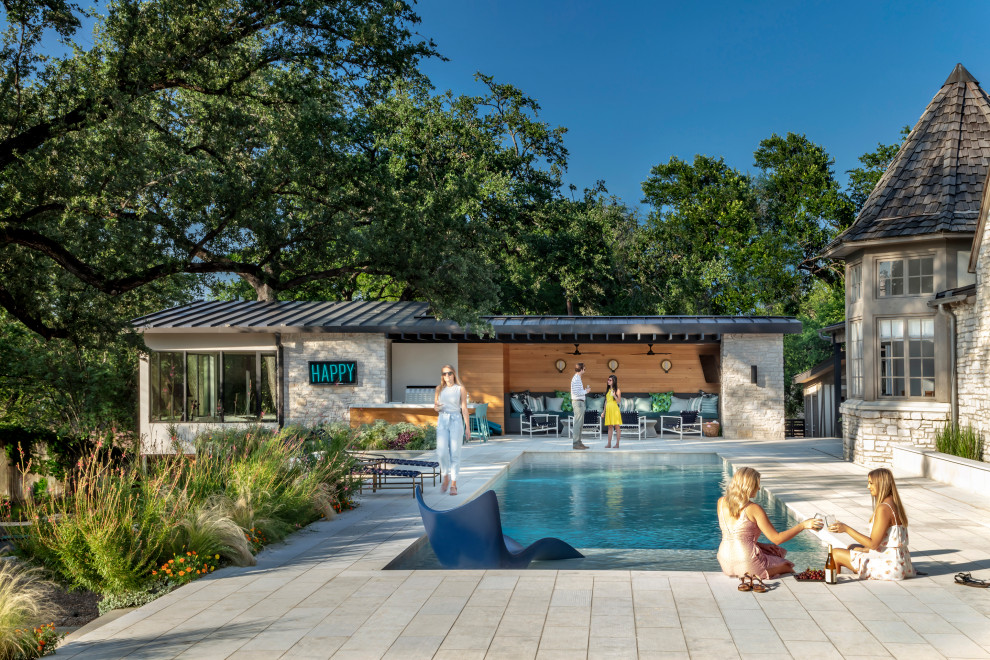 This is an example of a mid-sized modern backyard patio in Austin with a fire feature, natural stone pavers and a gazebo/cabana.
