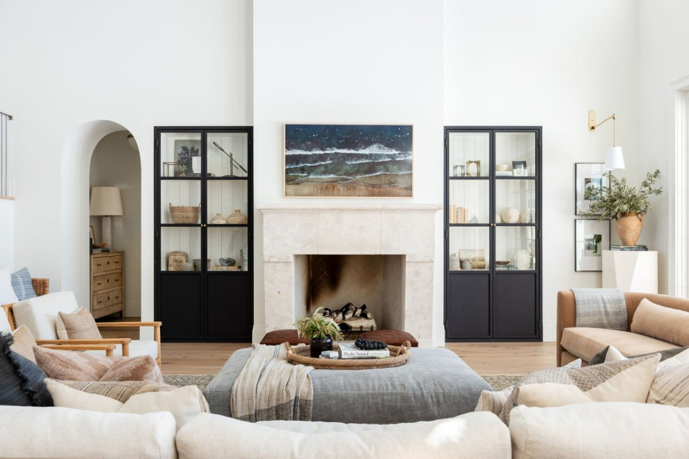 Large transitional open concept light wood floor, brown floor and vaulted ceiling family room photo in Salt Lake City with white walls, a standard fireplace, a stone fireplace and a wall-mounted tv