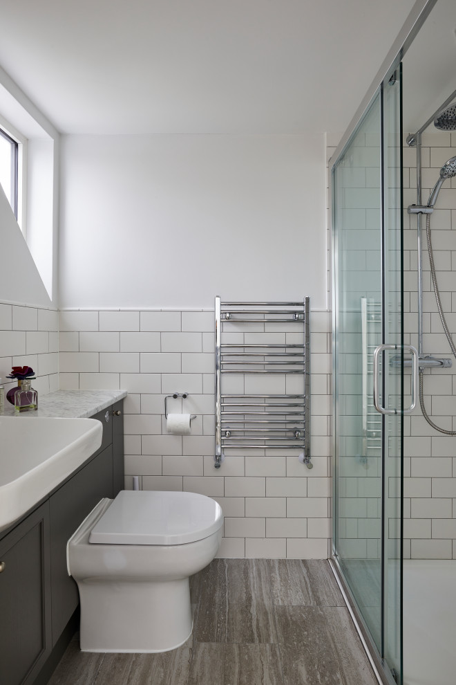 Inspiration for a small modern master bathroom in London with shaker cabinets, an open shower, a one-piece toilet, white tile, ceramic tile, white walls, wood-look tile, a drop-in sink, marble benchtops, beige floor, a sliding shower screen, white benchtops, a single vanity and a built-in vanity.