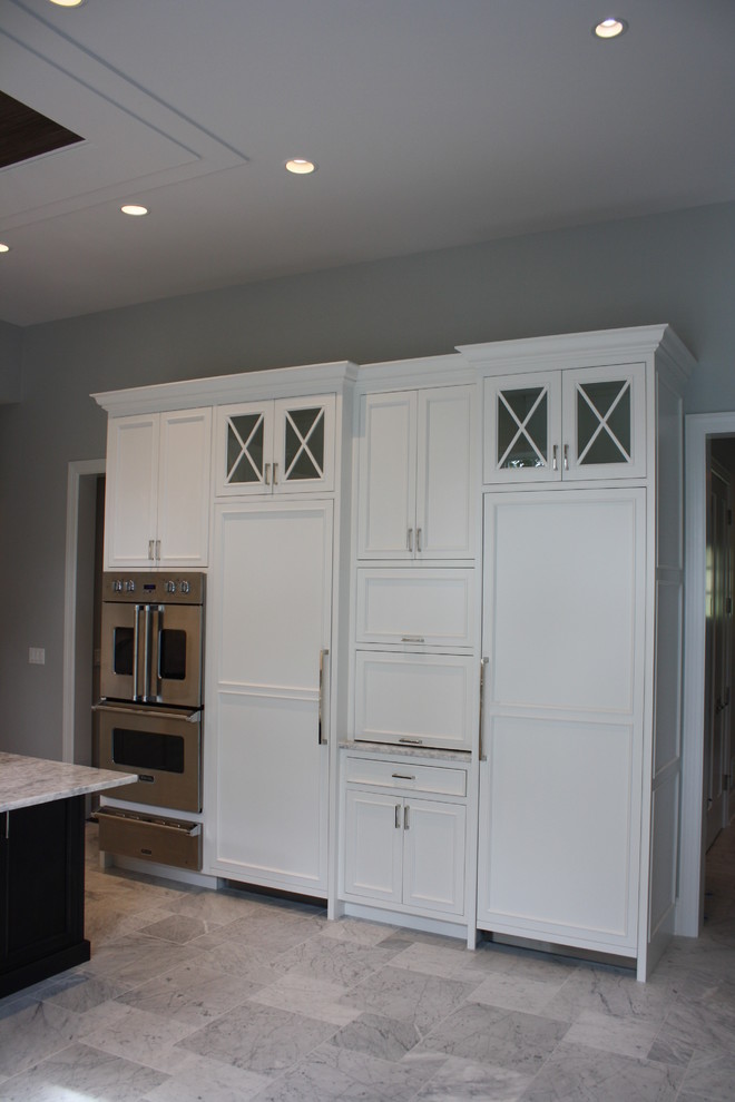 Large transitional u-shaped marble floor open concept kitchen photo in Chicago with a double-bowl sink, beaded inset cabinets, white cabinets, quartzite countertops, white backsplash, subway tile backsplash, stainless steel appliances and an island
