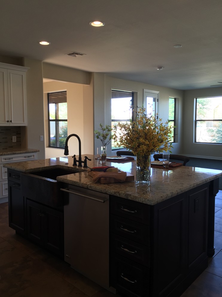 Example of a large transitional eat-in kitchen design in Phoenix with granite countertops, gray backsplash, stone tile backsplash, black appliances and an island