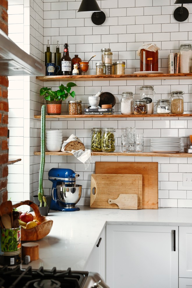 Inspiration for a mid-sized transitional l-shaped dark wood floor and brown floor eat-in kitchen remodel with an undermount sink, shaker cabinets, blue cabinets, quartz countertops, white backsplash, subway tile backsplash, stainless steel appliances, an island and white countertops