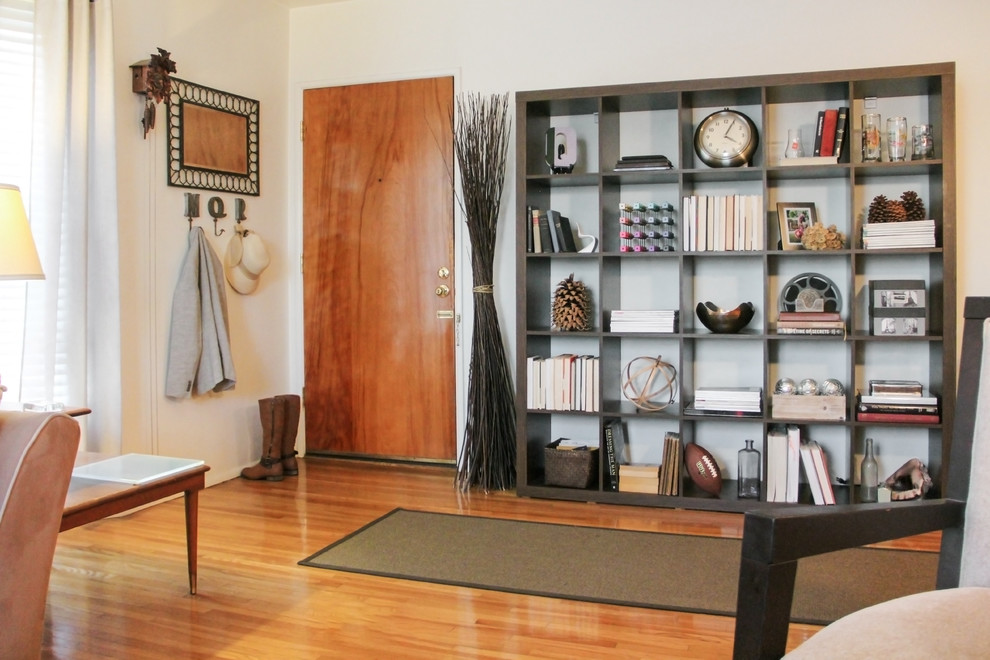 Inspiration for a small transitional medium tone wood floor and brown floor front door remodel in Los Angeles with white walls and a medium wood front door