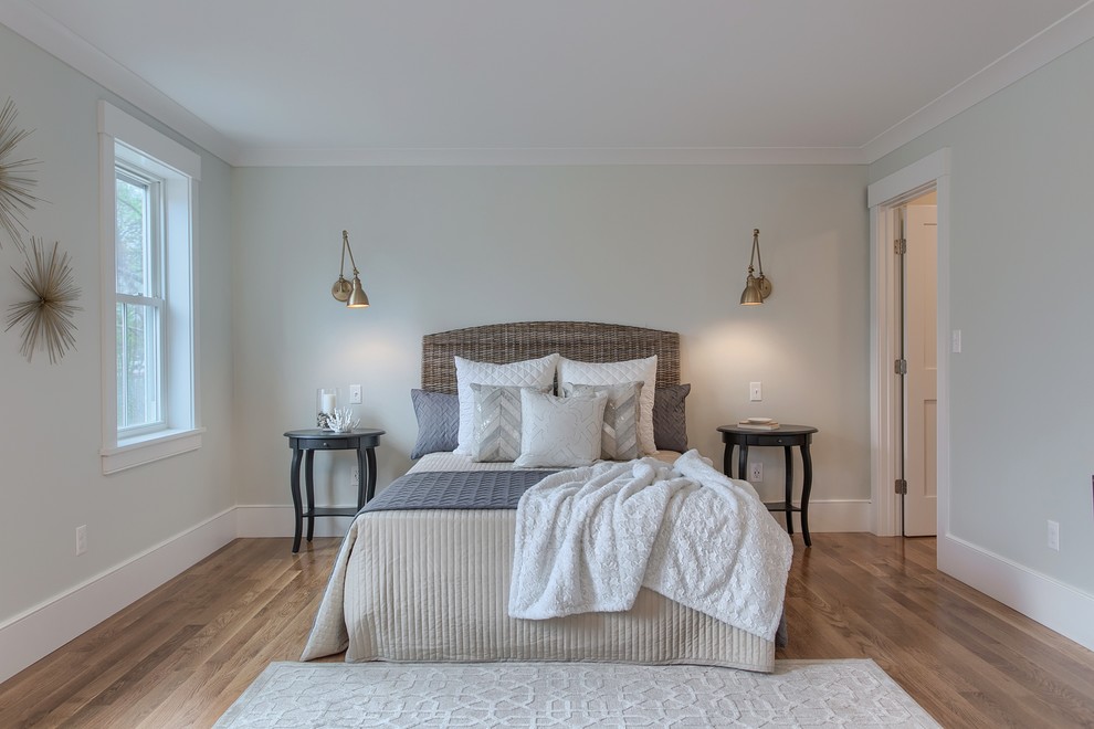 Photo of a mid-sized country master bedroom in Boston with grey walls, light hardwood floors and beige floor.