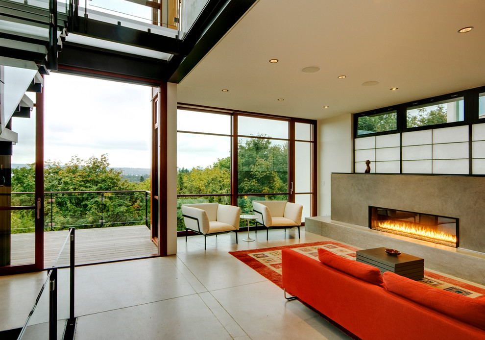 Mid-sized contemporary formal open concept living room in Seattle with a concrete fireplace surround, white walls, concrete floors, a ribbon fireplace and no tv.