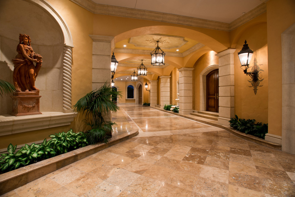 Expansive mediterranean hallway in New York with yellow walls and marble floors.