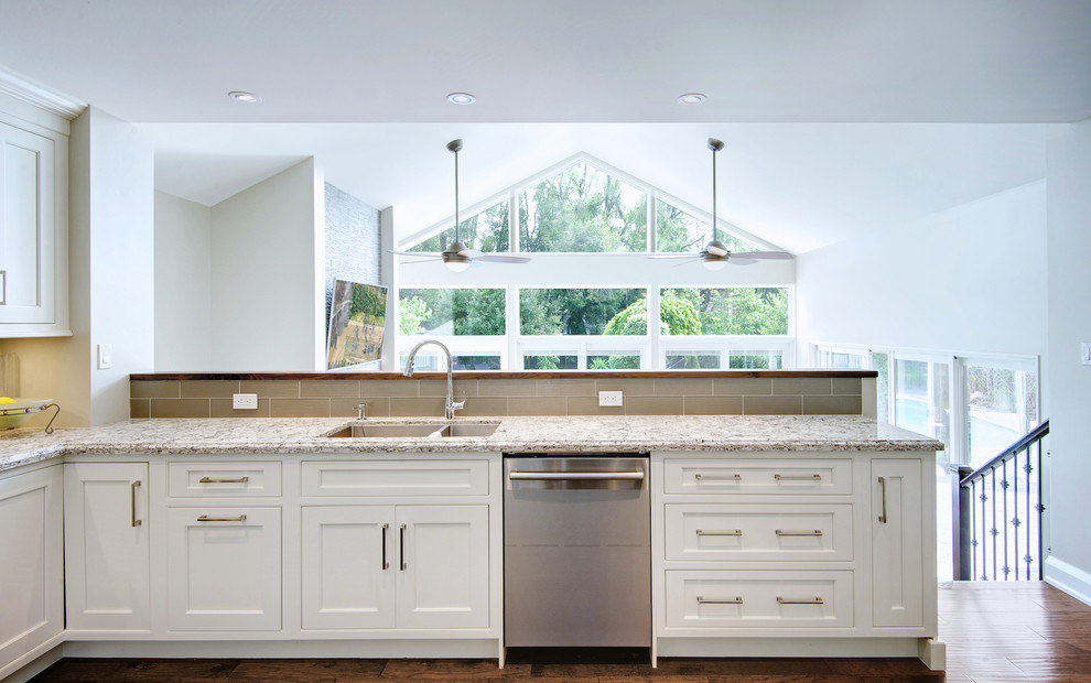 Mid-sized transitional u-shaped medium tone wood floor open concept kitchen photo in Toronto with an undermount sink, shaker cabinets, white cabinets, quartz countertops, gray backsplash, glass tile backsplash, stainless steel appliances and an island
