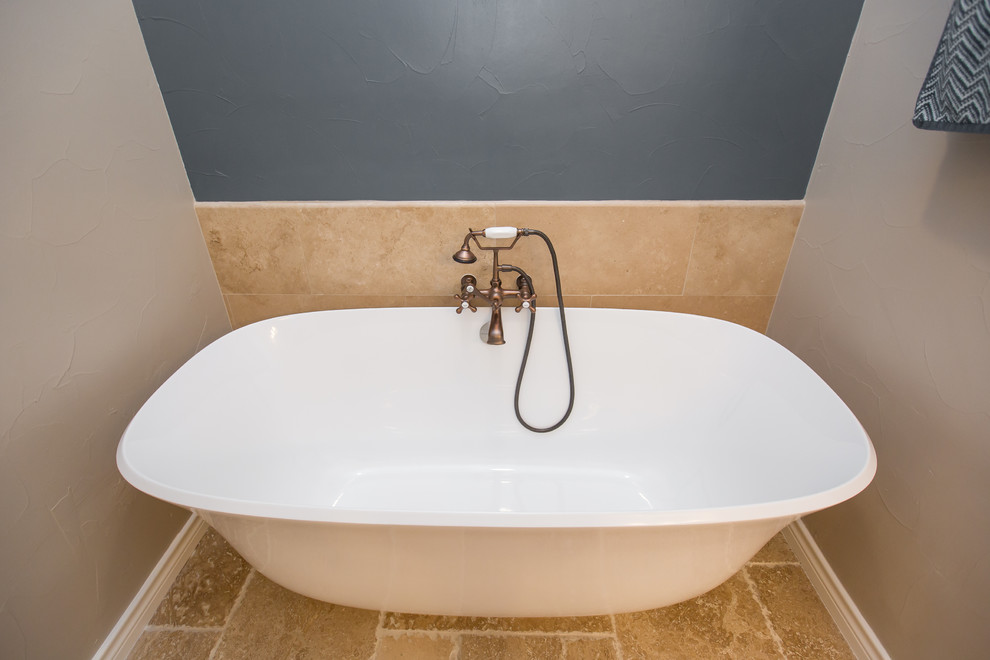 Diseño de cuarto de baño principal de tamaño medio con bañera exenta, baldosas y/o azulejos beige, paredes beige y encimera de granito