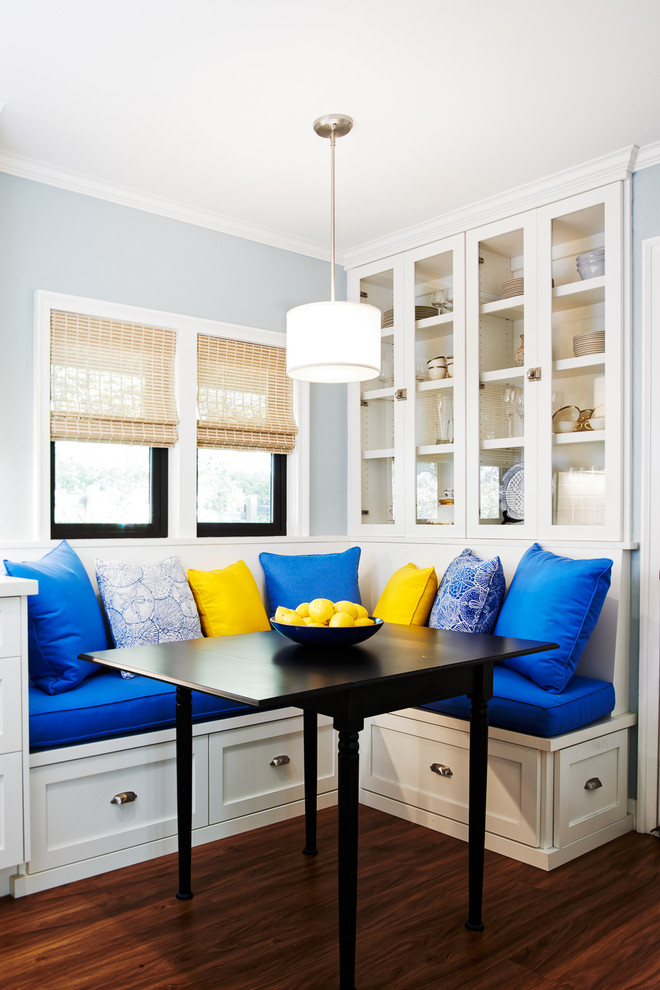 This is an example of a beach style dining room in Other with blue walls, dark hardwood floors and brown floor.