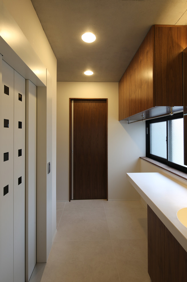 Photo of a mid-sized modern powder room in Tokyo with beaded inset cabinets, dark wood cabinets, a one-piece toilet, white tile, cement tile, white walls, cement tiles, an integrated sink, solid surface benchtops, beige floor and white benchtops.