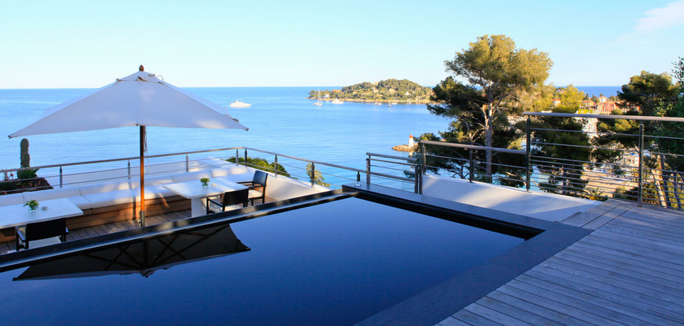 Photo of a large contemporary rectangular lap pool in Nice with decking.