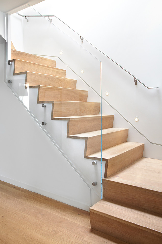 Photo of a contemporary wood staircase in Toronto with wood risers.