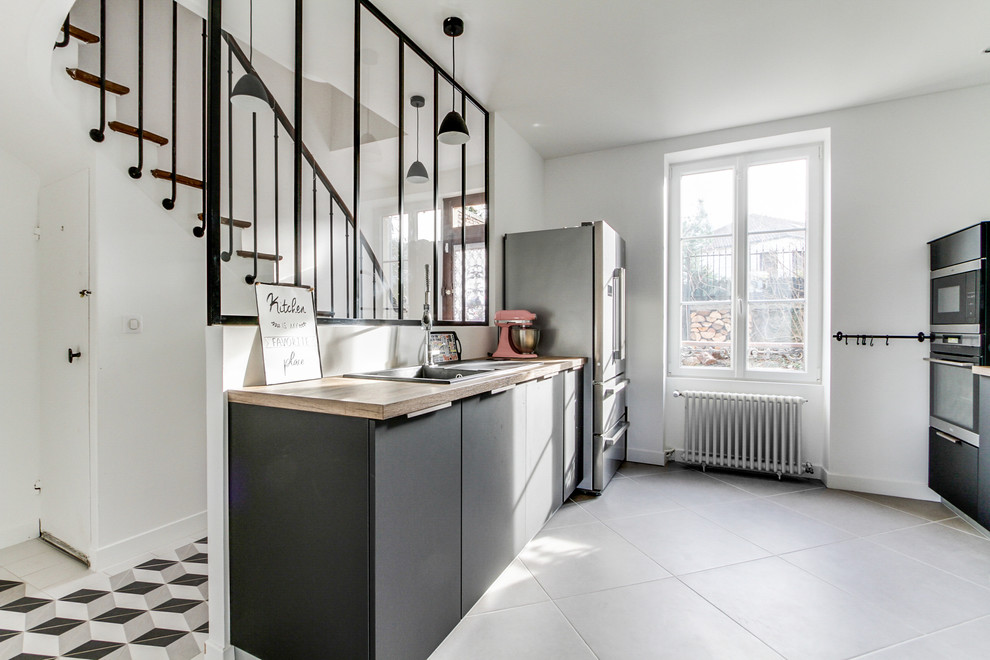 Design ideas for a large scandinavian galley eat-in kitchen in Paris with an undermount sink, beaded inset cabinets, grey cabinets, black appliances, ceramic floors, grey floor, beige benchtop, a peninsula and laminate benchtops.